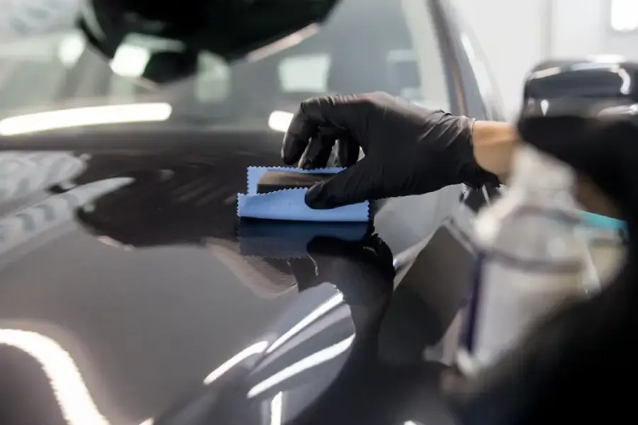 Ceramic coating being applied by hand to a car panel