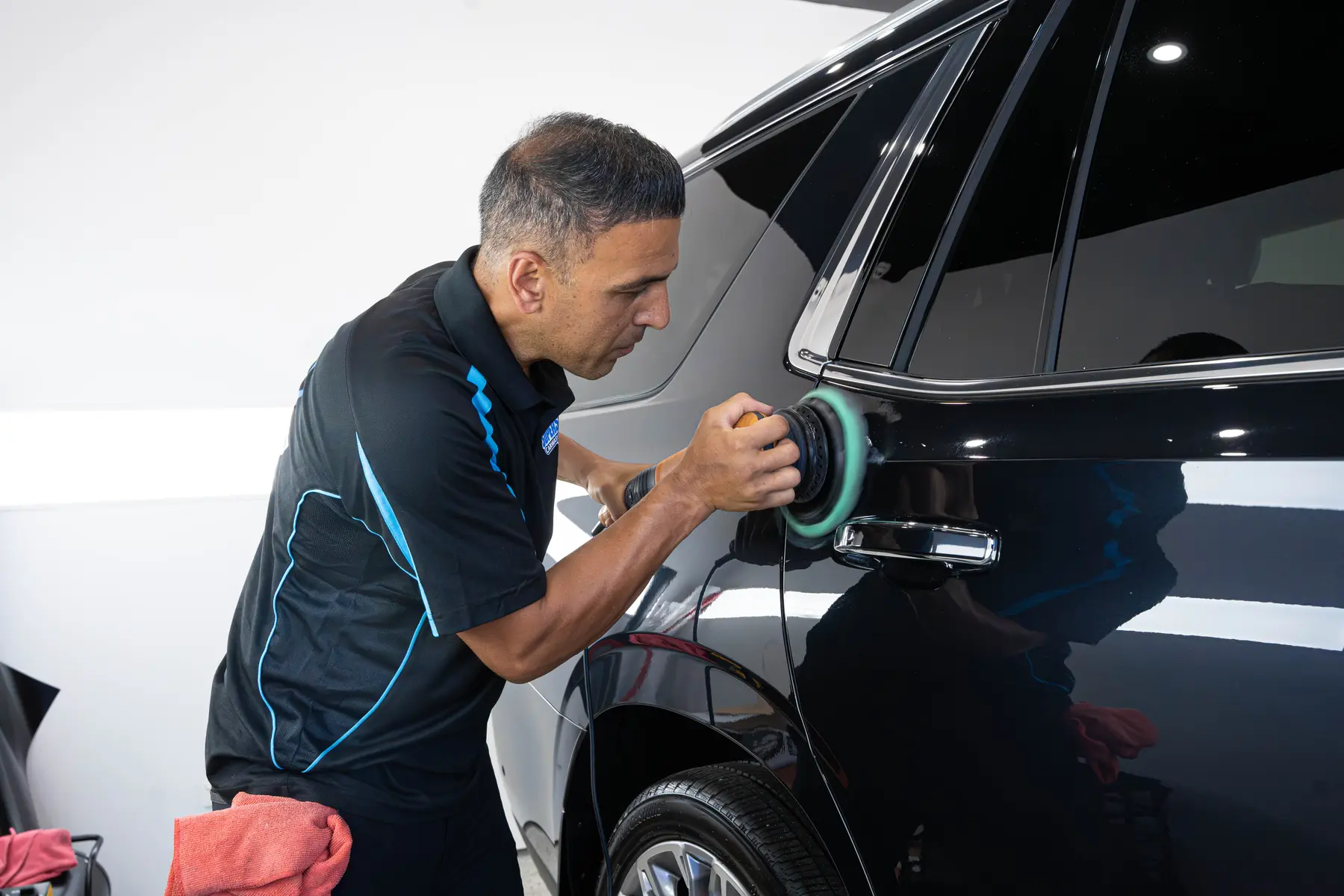 Machine polishing a dark panel at Super Shine