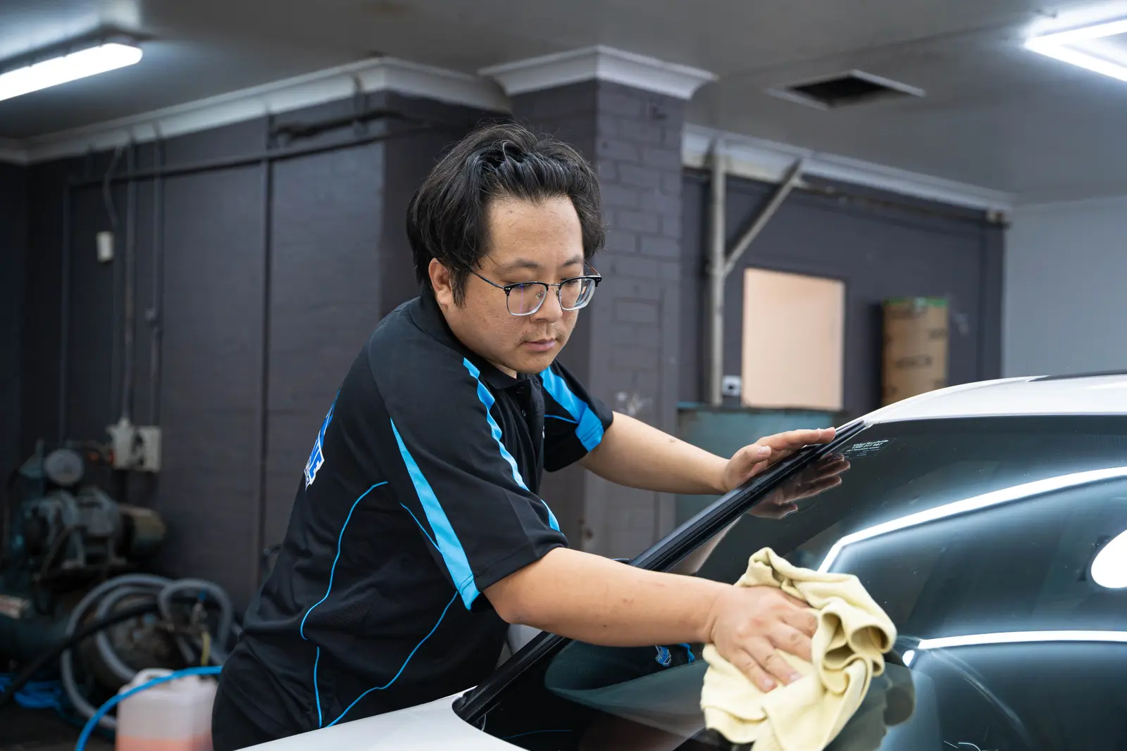 Super Shine technician finishing glass